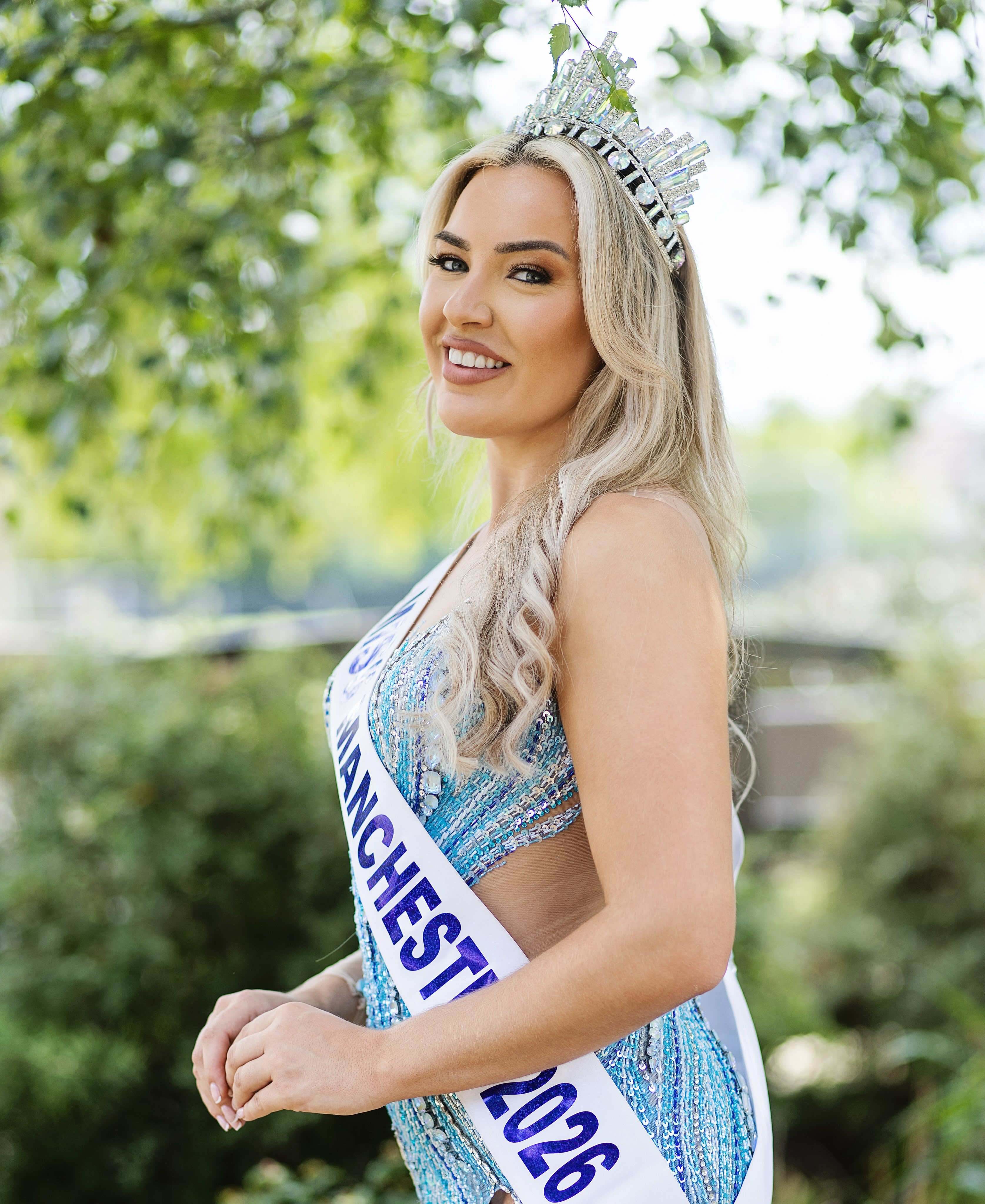 Clare Hopwood wearing her Miss Manchester crown and sash outdoors